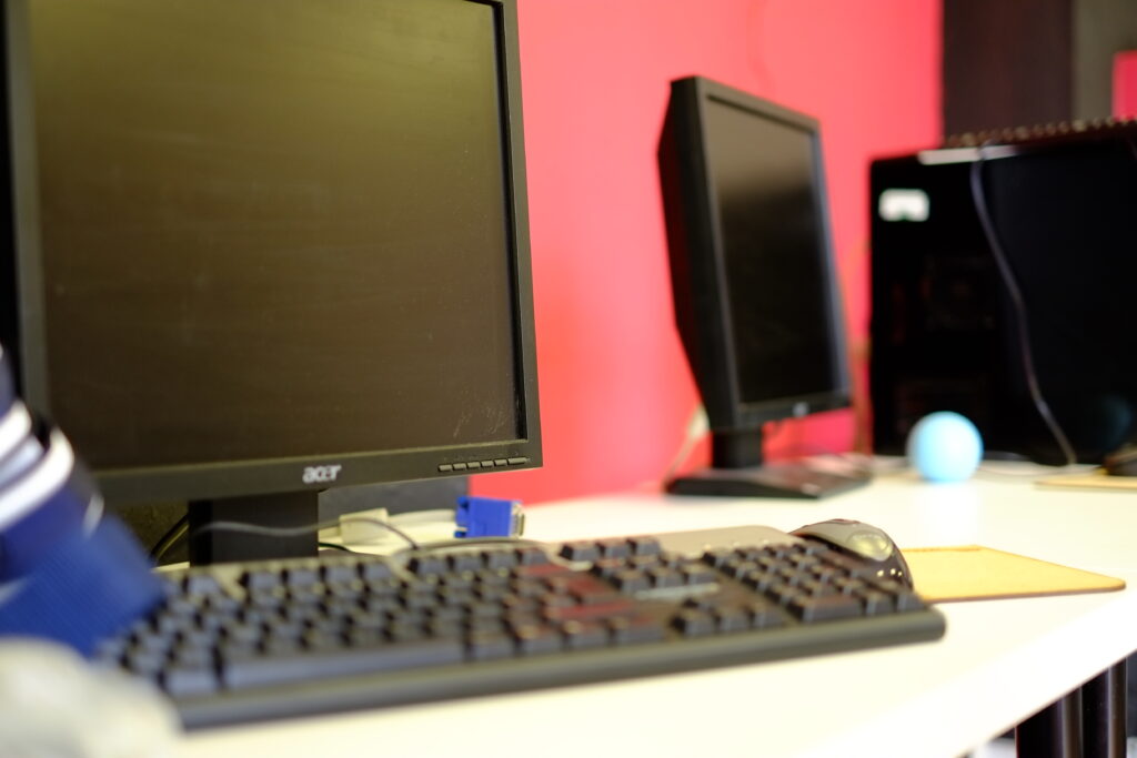 Monitors, mice, and keyboards on a workstation.